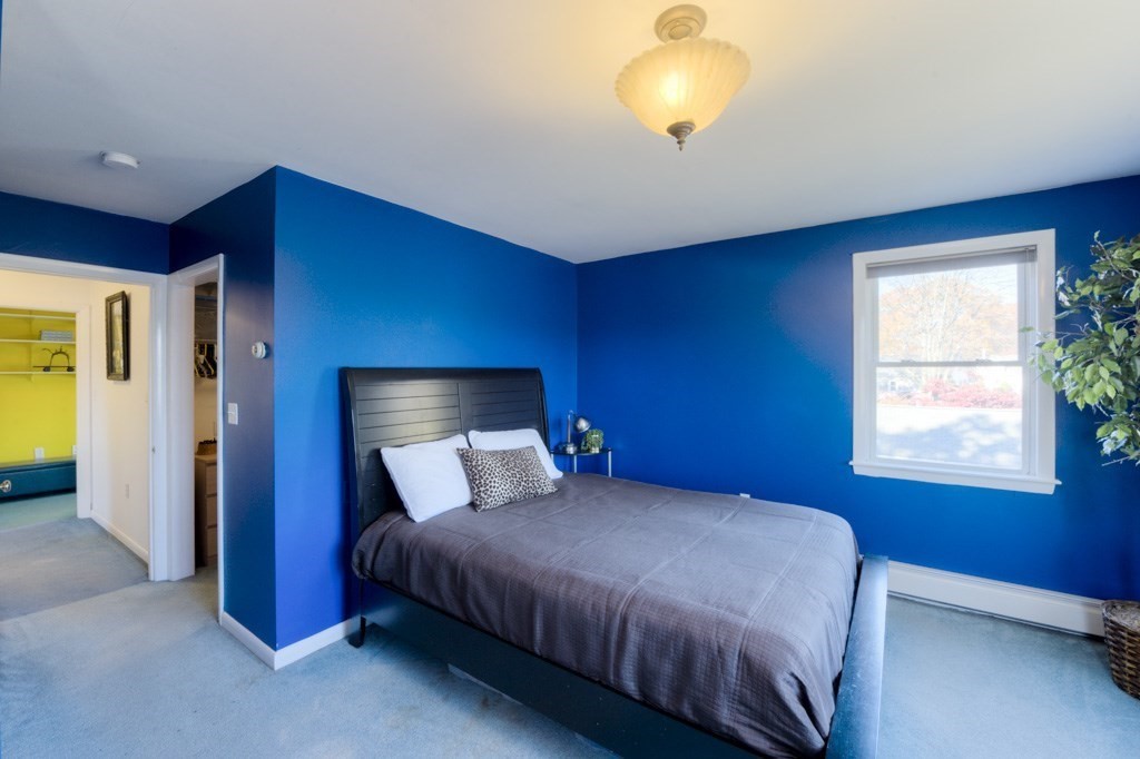 18 Bergin Lane Worcester, MA 01602 - Photo 28 of 42 a bedroom with a bed and a chandelier