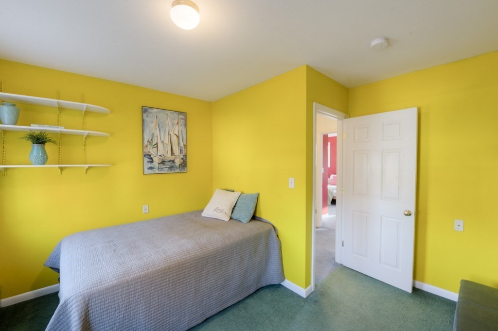 18 Bergin Lane Worcester, MA 01602 - Photo 33 of 42 a bedroom with a bed and a wall painting