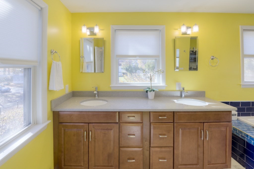 18 Bergin Lane Worcester, MA 01602 - Photo 37 of 42 a bathroom with a granite countertop sink and a mirror