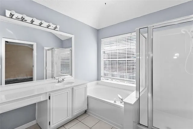 a bathroom with a tub sink and mirror