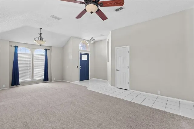 a view of an empty room with a ceiling fan
