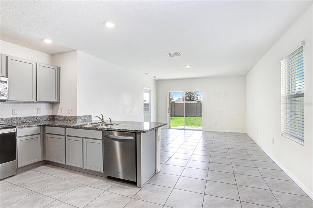 31210 Penny Surf Loop Wesley Chapel, FL 33545 - Photo 2 of 39 a kitchen with a sink a counter top space and appliances