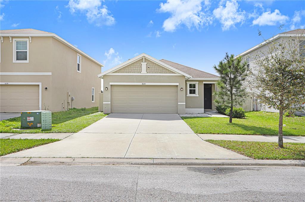 31210 Penny Surf Loop Wesley Chapel, FL 33545 - Photo 21 of 39 a front view of a house with a yard and garage
