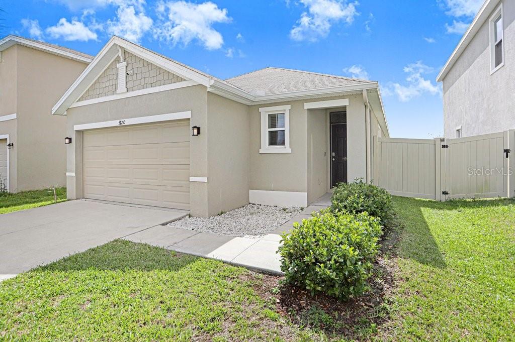 31210 Penny Surf Loop Wesley Chapel, FL 33545 - Photo 22 of 39 a front view of a house with garden