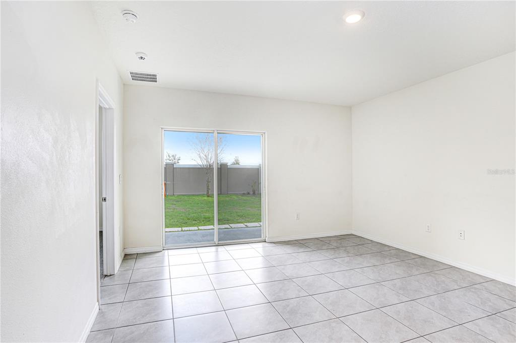 31210 Penny Surf Loop Wesley Chapel, FL 33545 - Photo 8 of 39 a view of an empty room with glass door