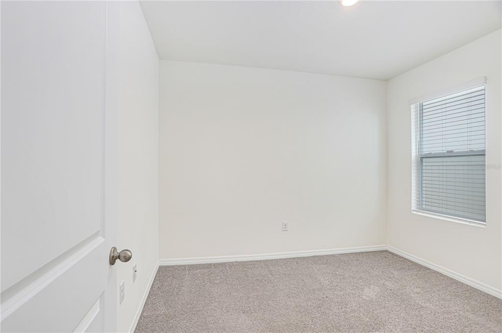 31210 Penny Surf Loop Wesley Chapel, FL 33545 - Photo 9 of 39 a view of an empty room with a window