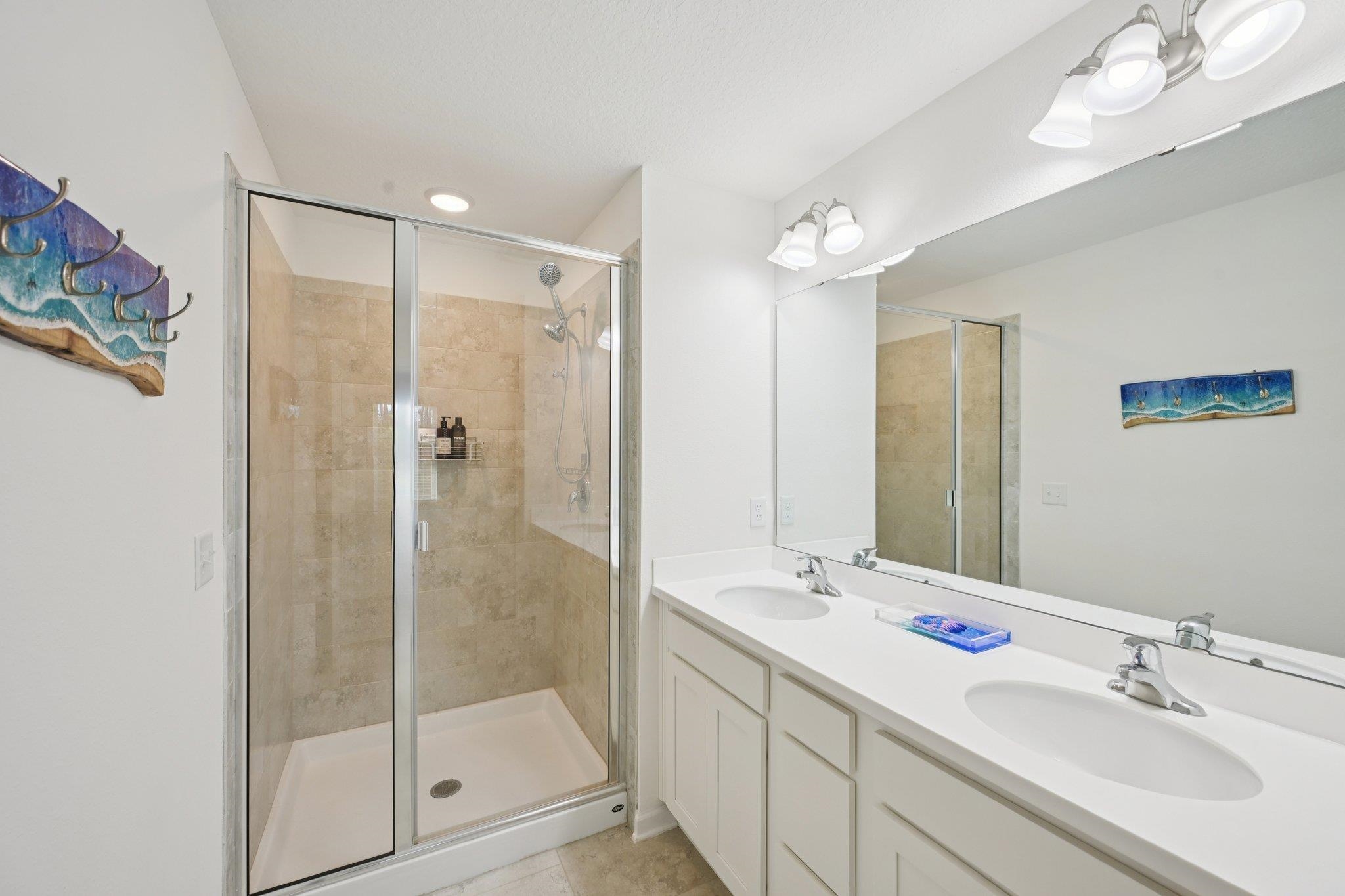 22 Ridge Lake Road St. Augustine, FL 32086 - Photo 15 of 31 Full bathroom with a shower stall, double vanity, and light tile patterned floors