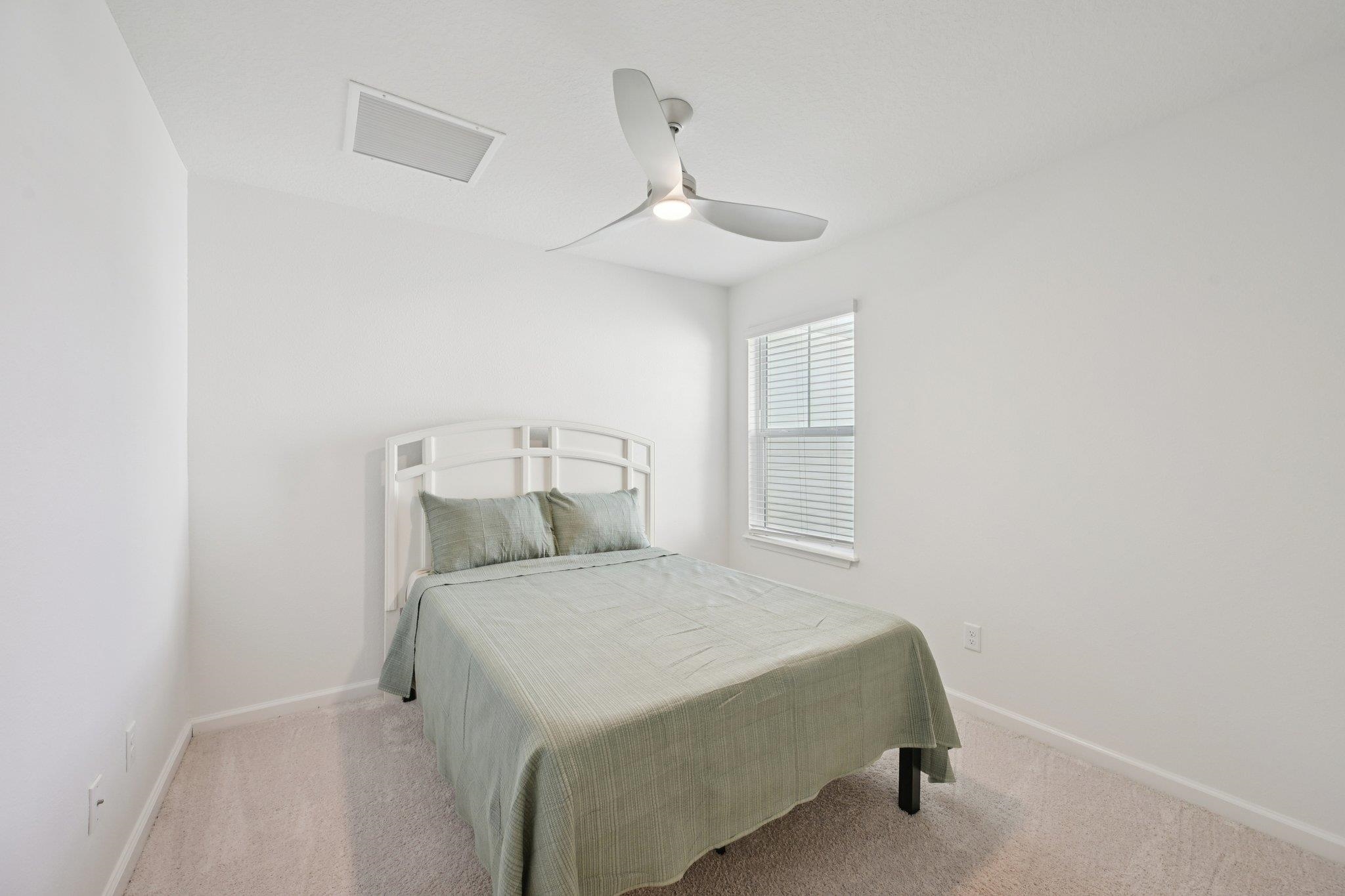 22 Ridge Lake Road St. Augustine, FL 32086 - Photo 17 of 31 a bedroom with a bed and a ceiling fan