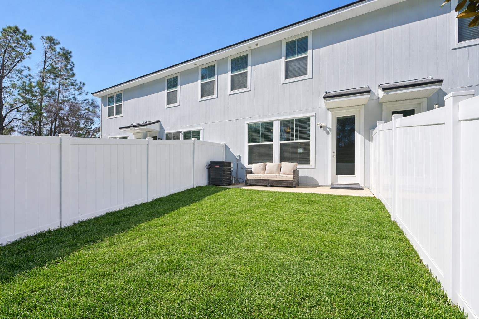 22 Ridge Lake Road St. Augustine, FL 32086 - Photo 17 of 31 Back of house featuring a fenced backyard, outdoor furniture, and a patio