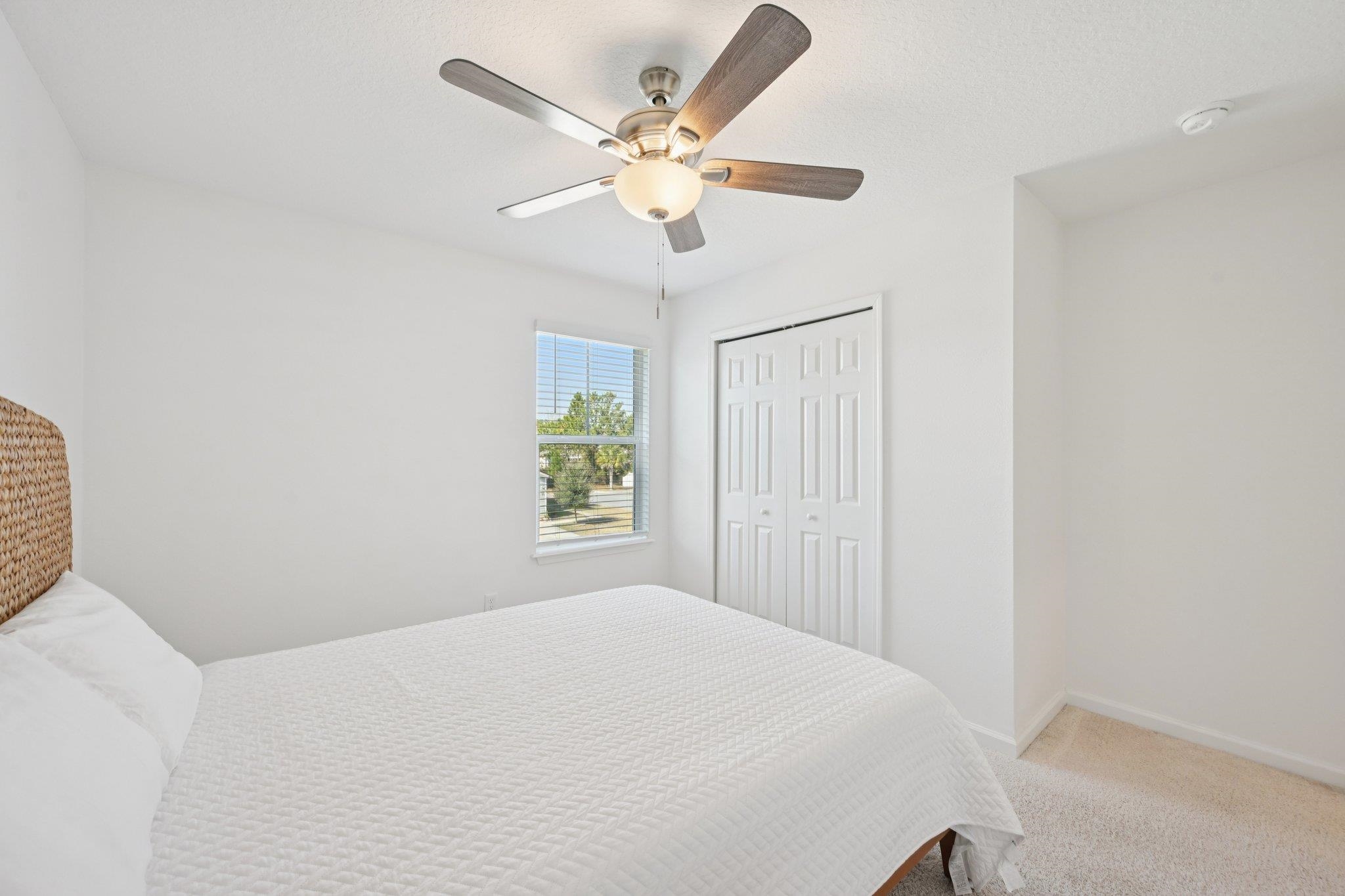 22 Ridge Lake Road St. Augustine, FL 32086 - Photo 20 of 31 Bedroom with light carpet, a ceiling fan, and a closet