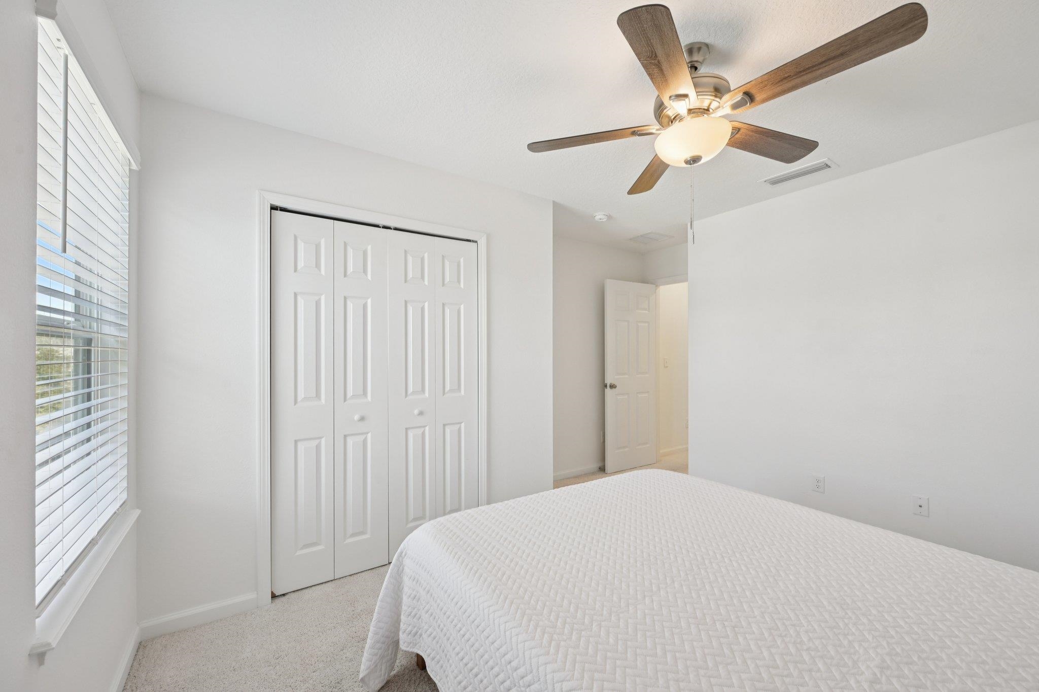 22 Ridge Lake Road St. Augustine, FL 32086 - Photo 21 of 31 Carpeted bedroom with multiple windows, a ceiling fan, and a closet