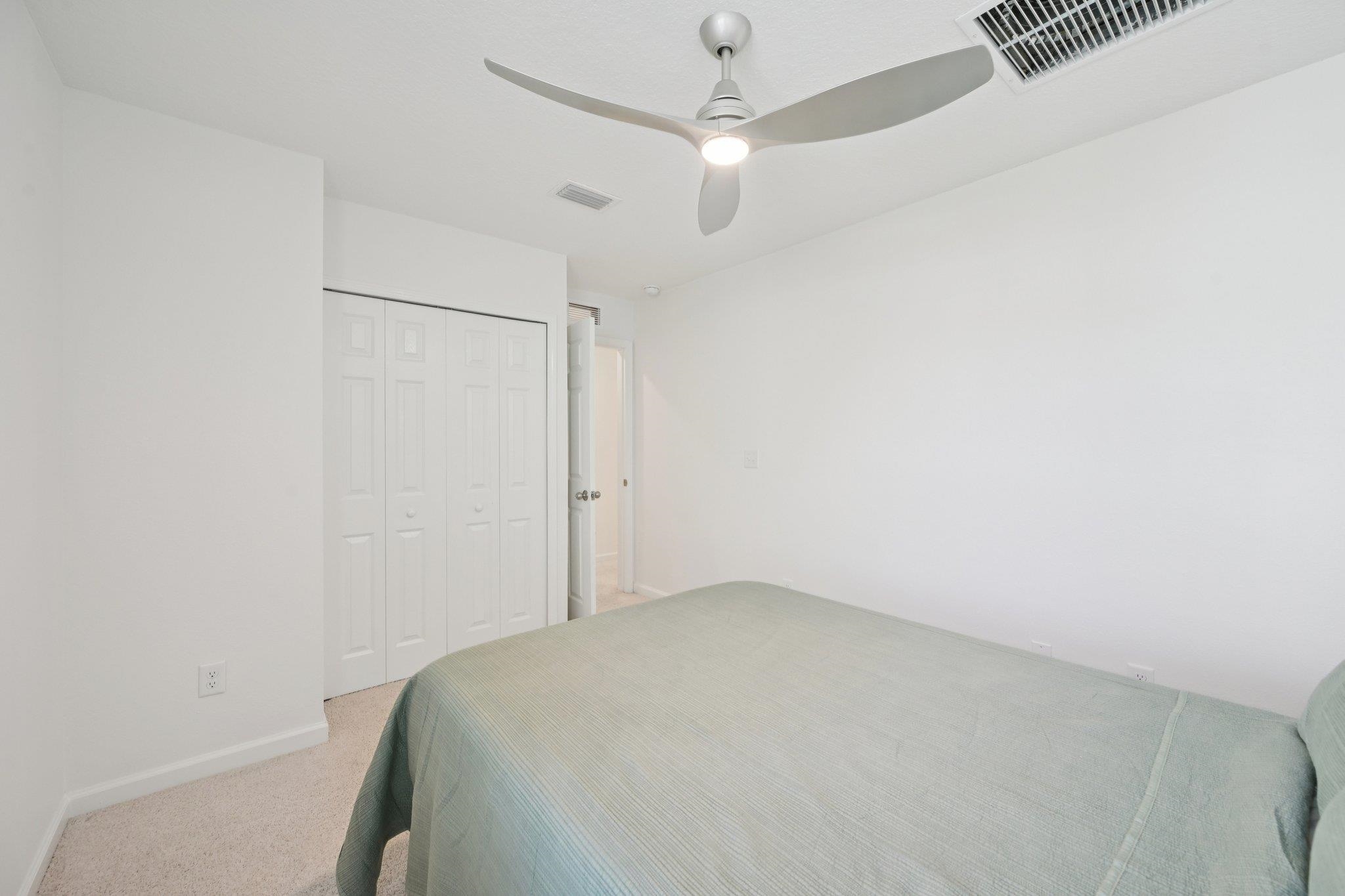 22 Ridge Lake Road St. Augustine, FL 32086 - Photo 25 of 31 Bedroom featuring light colored carpet, a closet, and a ceiling fan
