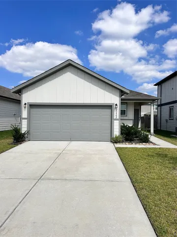 a front view of house along with trees