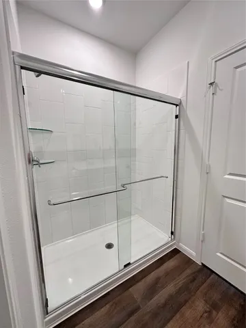 a bathroom with a glass door shower