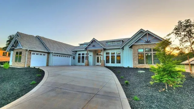 a front view of a house with a garden