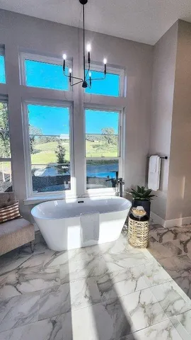 a bathroom with a granite countertop sink a toilet and a mirror