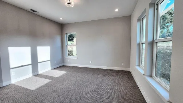 a kitchen with stainless steel appliances kitchen island granite countertop a stove a sink a dining table and chairs with wooden floor