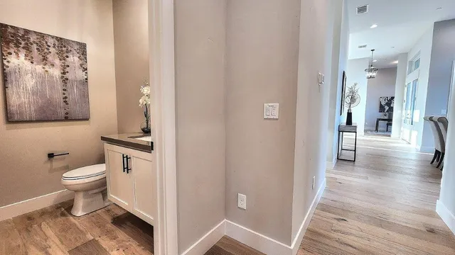 an aerial view of residential houses with outdoor space and trees