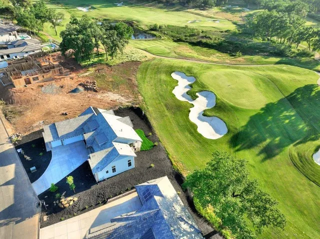 a spacious bedroom with a bed and glass walk in closet