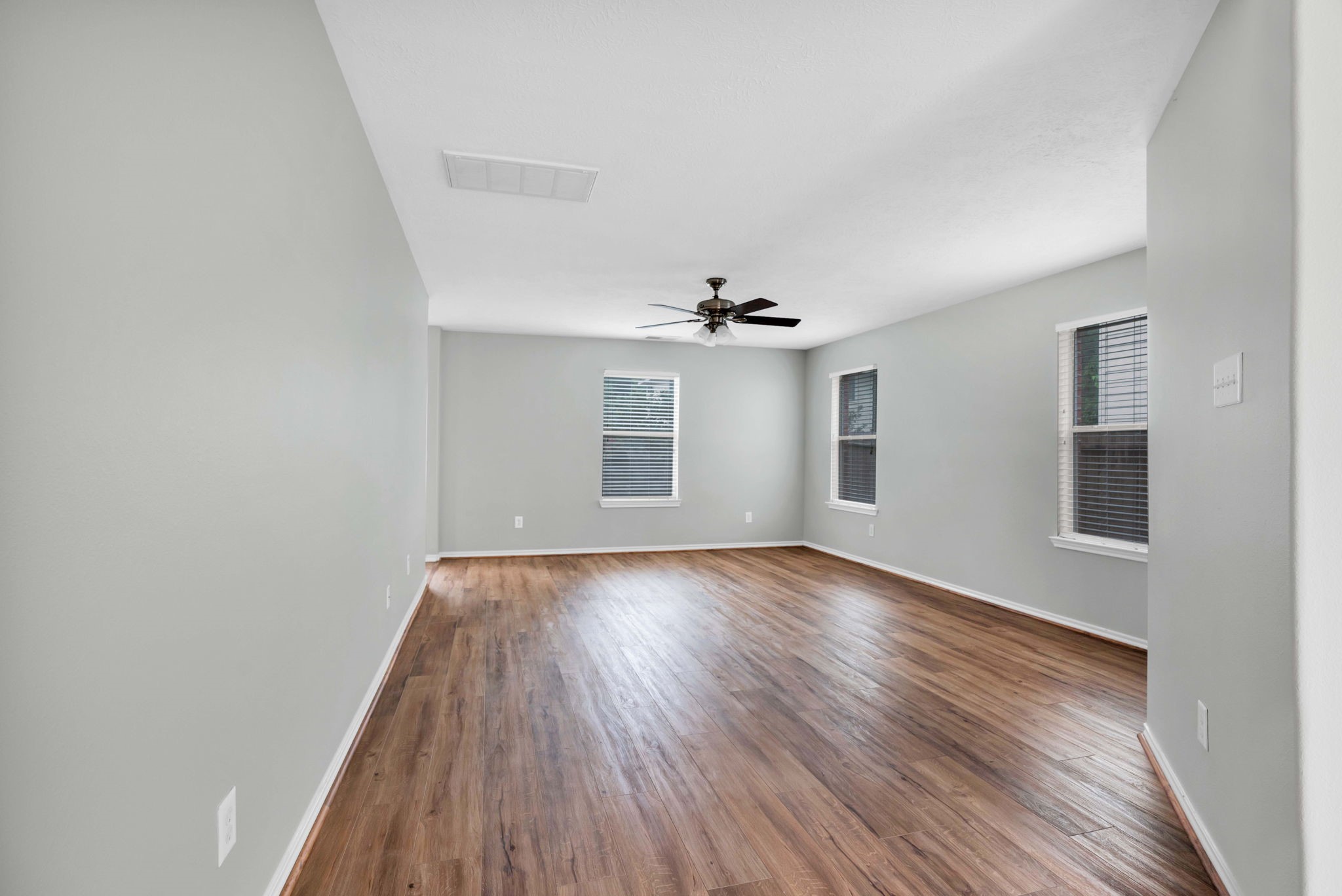 7215 Cool Spring Court Magnolia, TX 77354 - Photo 5 of 23 an empty room with wooden floor and windows