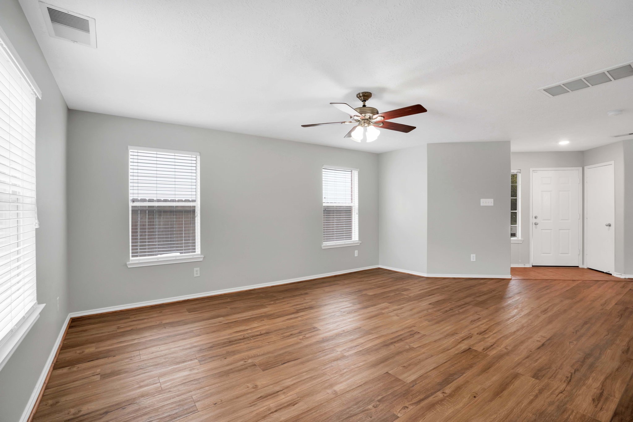 7215 Cool Spring Court Magnolia, TX 77354 - Photo 7 of 23 a view of an empty room with a window and wooden floor