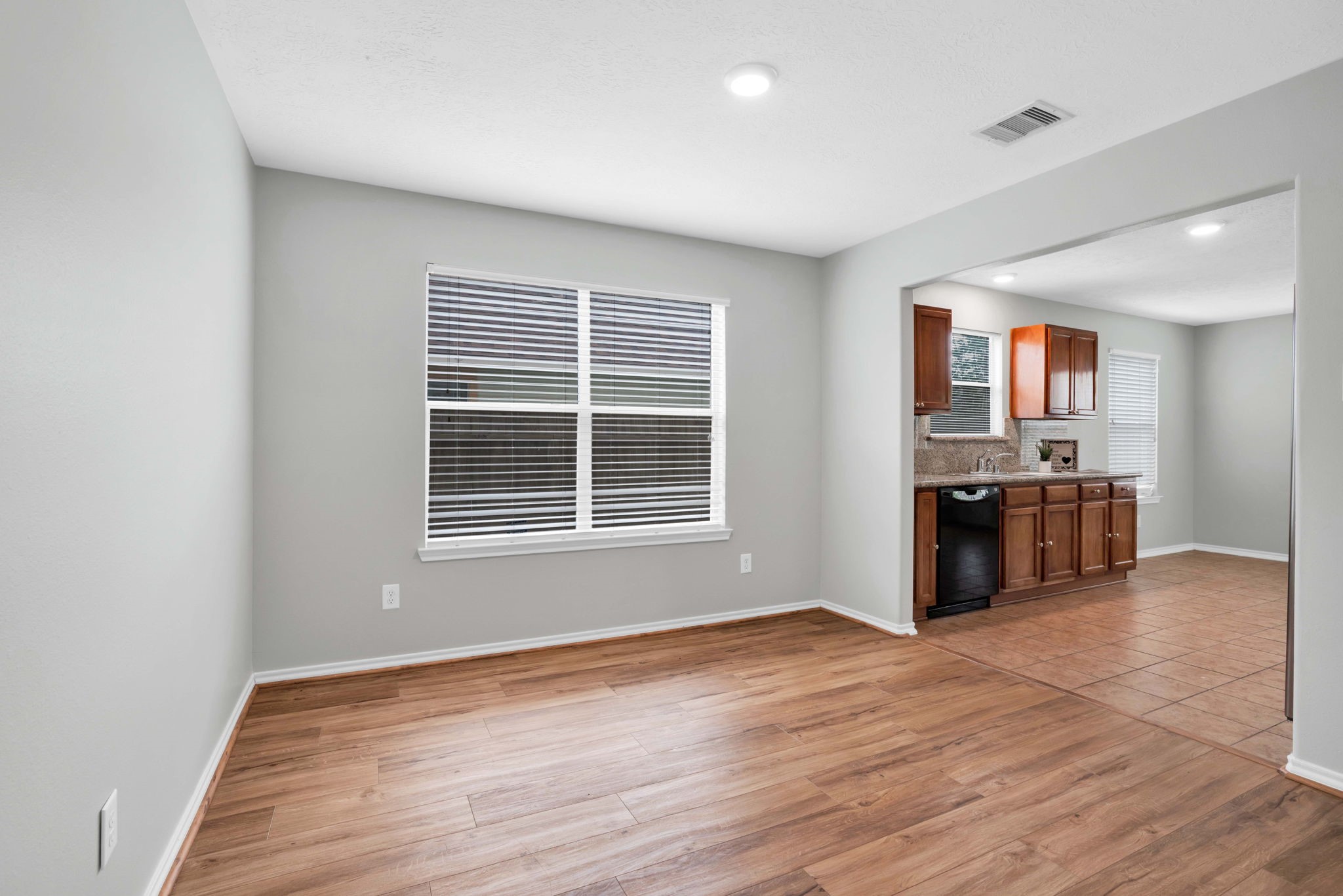 7215 Cool Spring Court Magnolia, TX 77354 - Photo 8 of 23 a view of kitchen with granite countertop cabinets and wooden floor