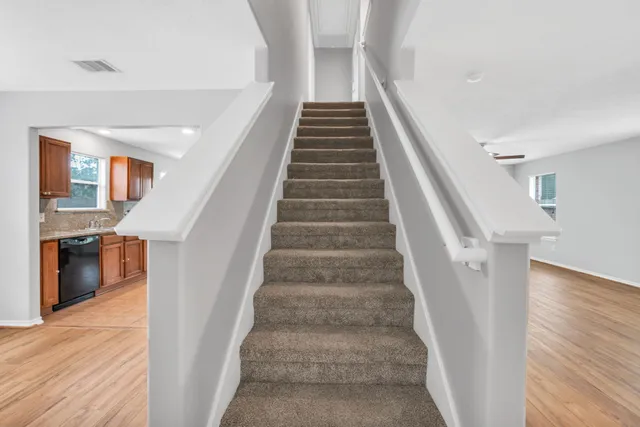 a view of entryway and hall with wooden floor