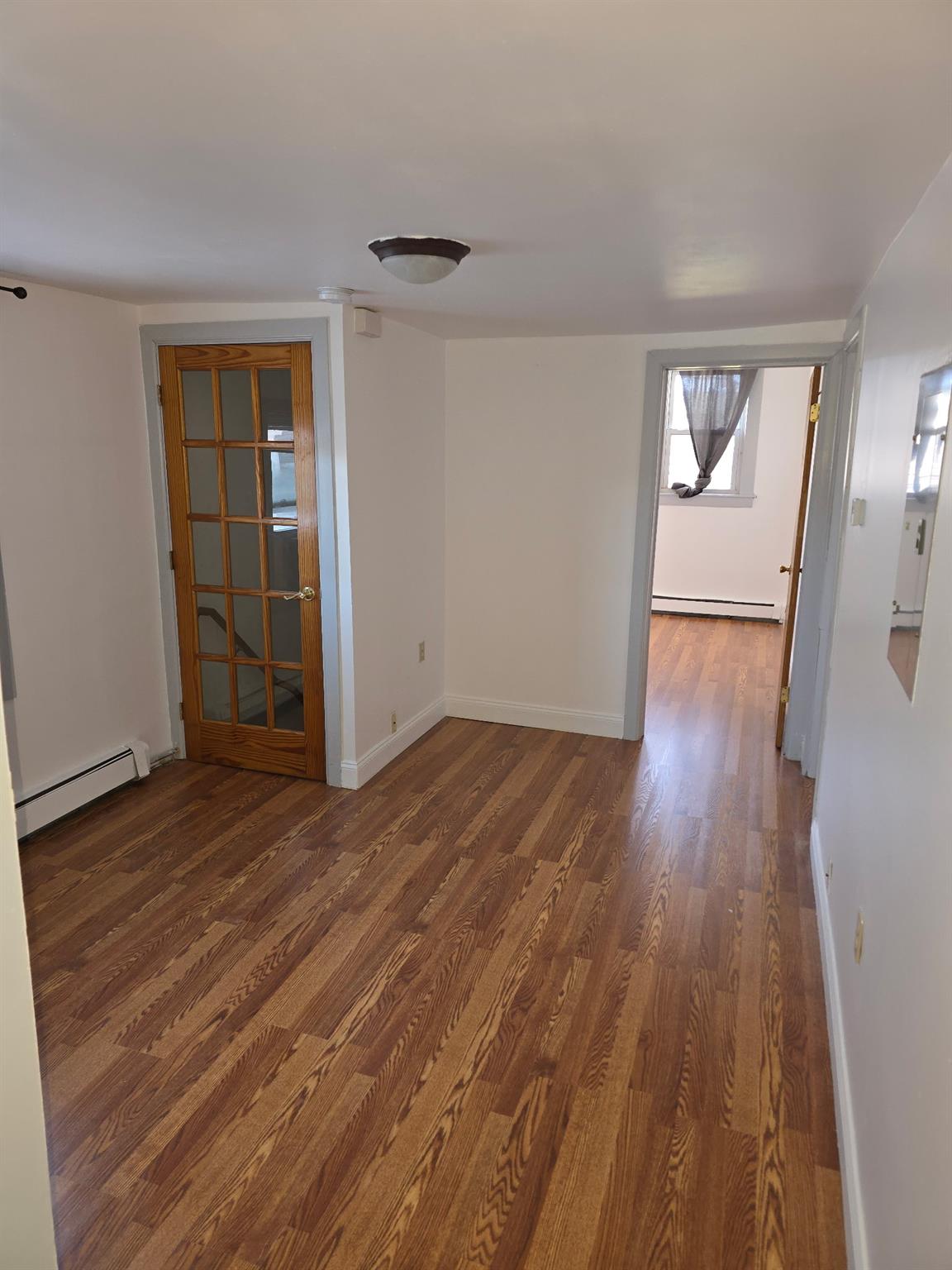 wooden floor in an empty room with a window