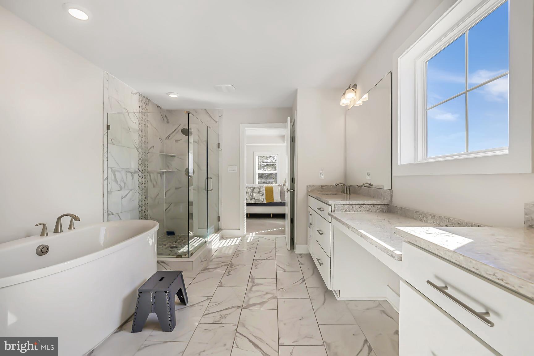 23420 Woodfield Road Gaithersburg, MD 20882 - Photo 21 of 50 a spacious bathroom with a tub sink and mirror