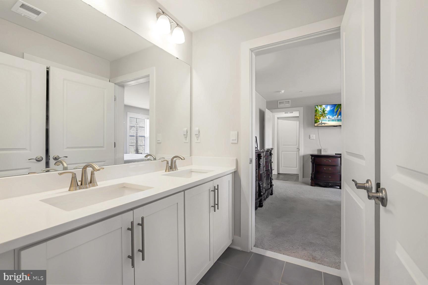23420 Woodfield Road Gaithersburg, MD 20882 - Photo 26 of 50 a spacious bathroom with a double vanity sink and mirror
