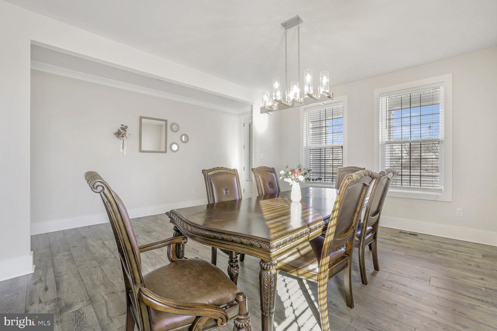 23420 Woodfield Road Gaithersburg, MD 20882 - Photo 5 of 50 a view of a dining room with furniture window and wooden floor