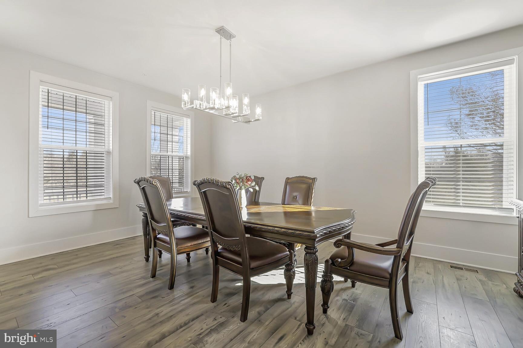 23420 Woodfield Road Gaithersburg, MD 20882 - Photo 6 of 50 a view of a dining room with furniture window and wooden floor