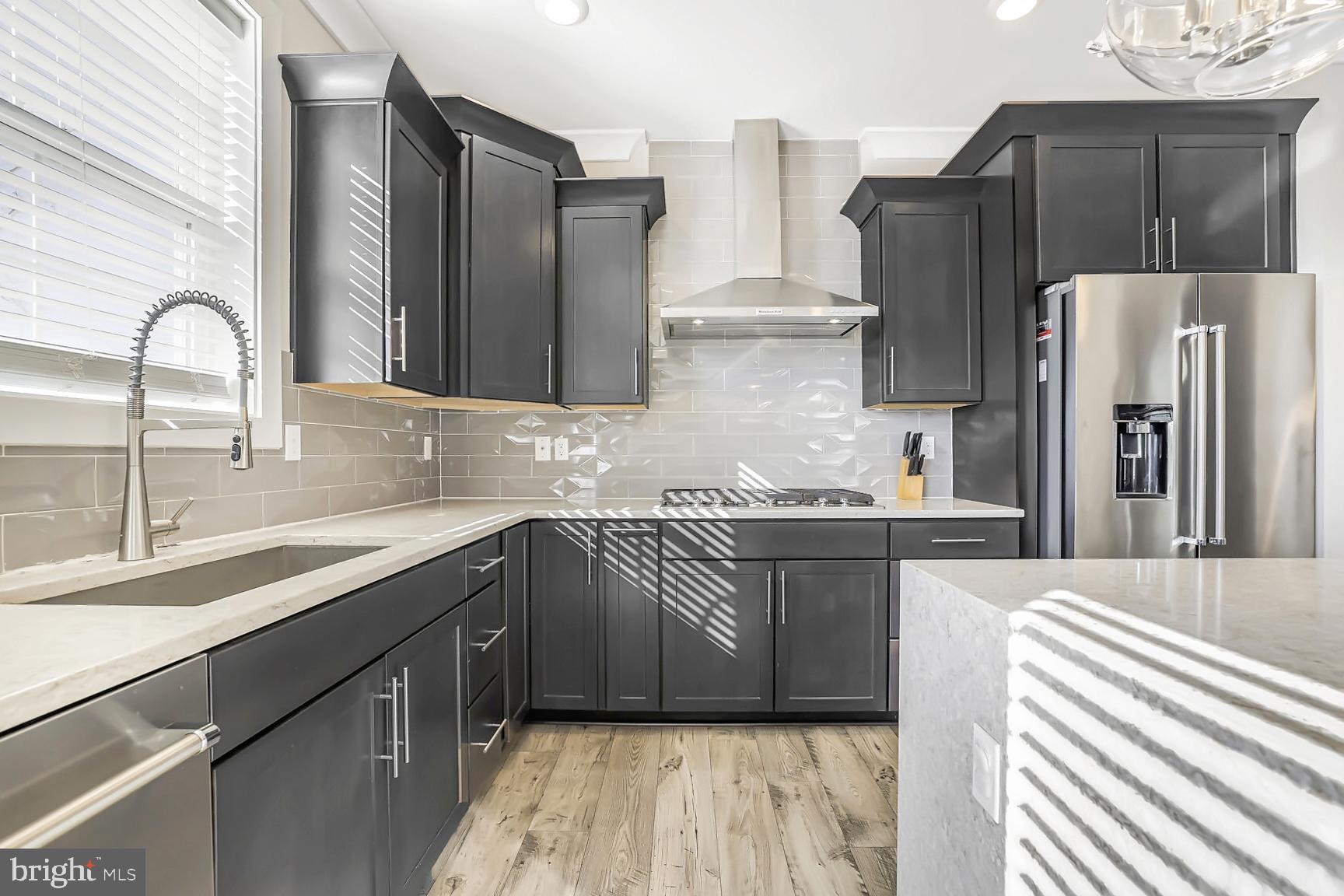 23420 Woodfield Road Gaithersburg, MD 20882 - Photo 10 of 50 a kitchen with granite countertop a refrigerator and a sink