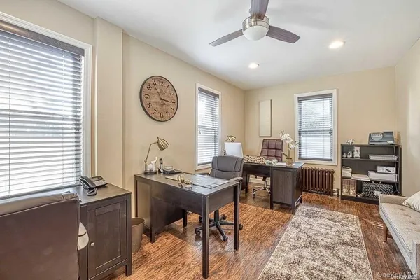 a view of a workspace with furniture and window