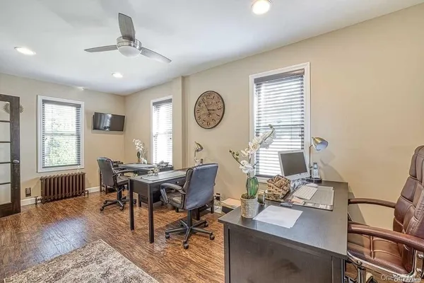 a view of a workspace with furniture and window in it