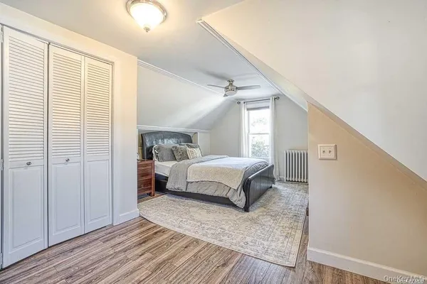 a spacious bedroom with a bed and a window