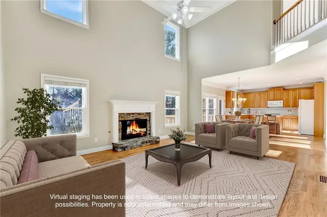 a kitchen with stainless steel appliances granite countertop a stove a sink dishwasher and a refrigerator with wooden floor