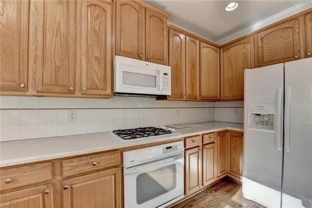 an empty room with chandelier fan and windows
