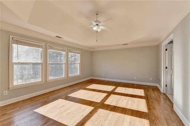 a bathroom with a tub a window and a shower