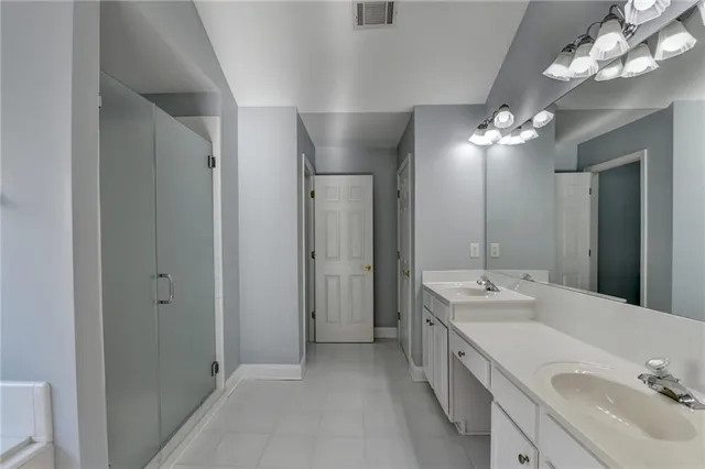 an empty room with wooden floor chandelier fan and windows