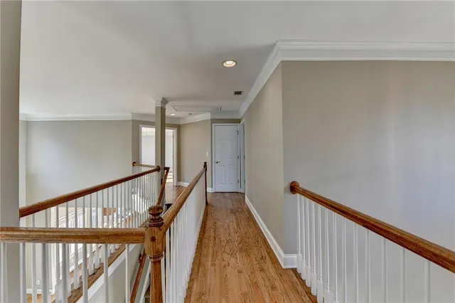 an empty room with chandelier fan and windows