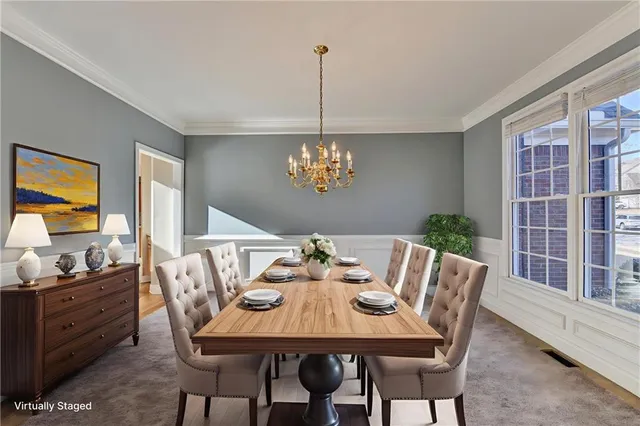 a view of a dining room with furniture a chandelier and wooden floor