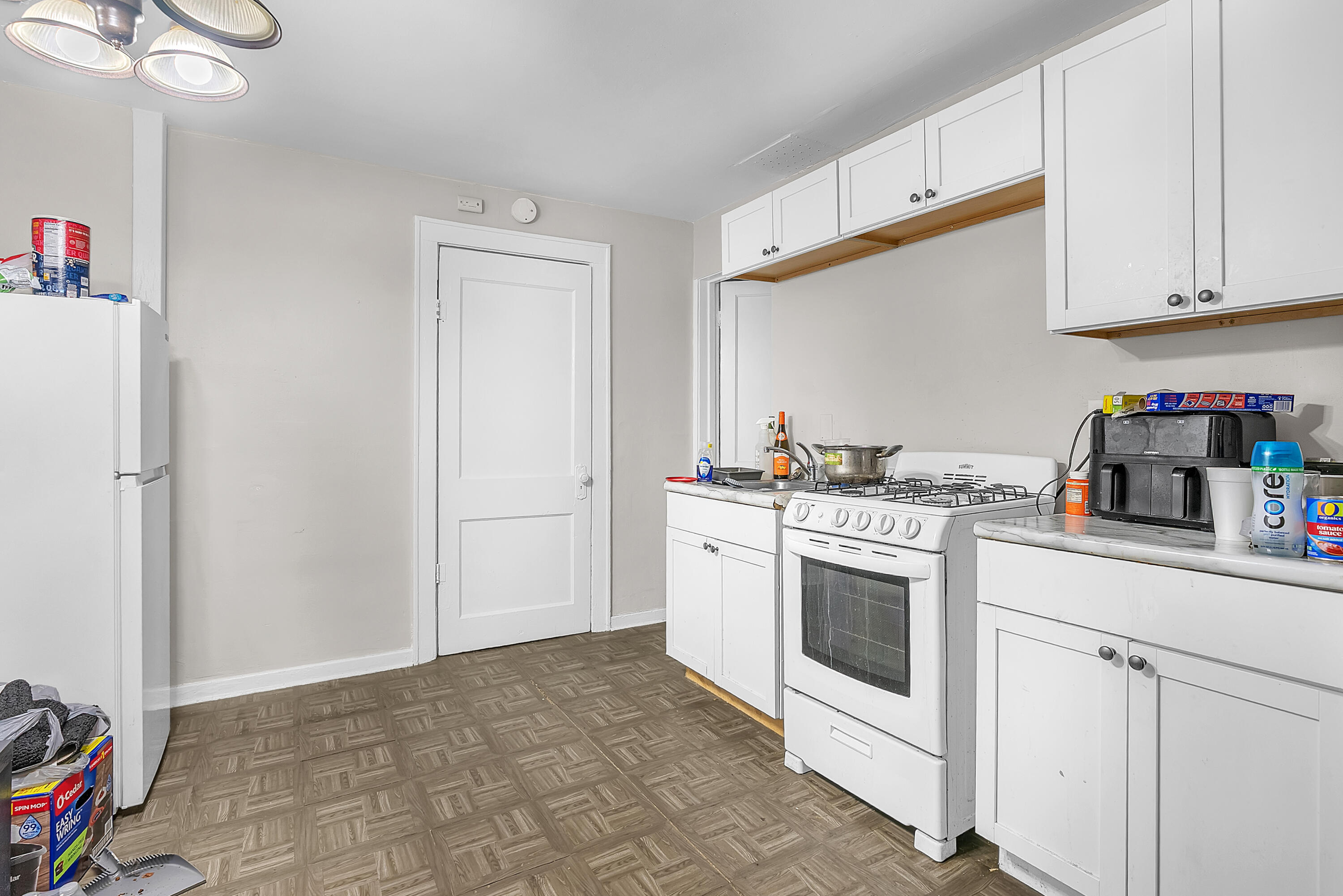 15 Rimbach Street Hammond, IN 46320 - Photo 15 of 31 a kitchen with cabinets and white appliances