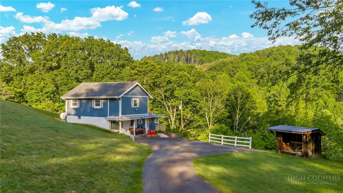 242 Ladd Parson Road Crumpler, NC 28617 - Photo 2 of 36 a view of a house with a big yard