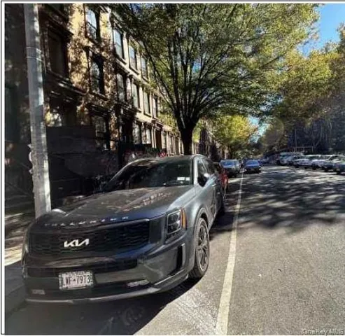 a view of a yard with car parked