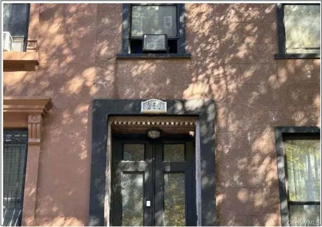 a view of a wooden door and brick wall