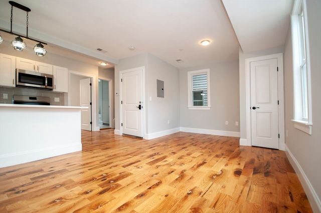 a view of a kitchen with a sink and a refrigerator