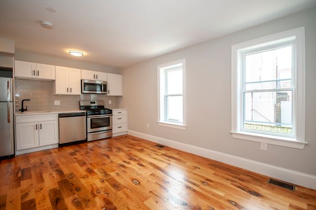 a kitchen with stainless steel appliances a refrigerator sink and stove