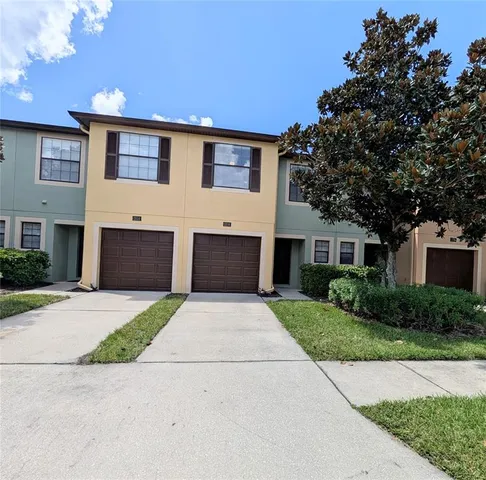a front view of a house with a yard and a garage