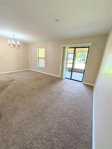 an empty room with windows and entrance